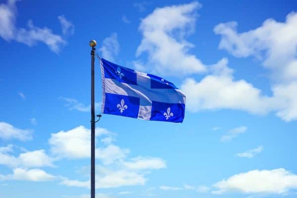 The Flag of Quebec flying against the sky